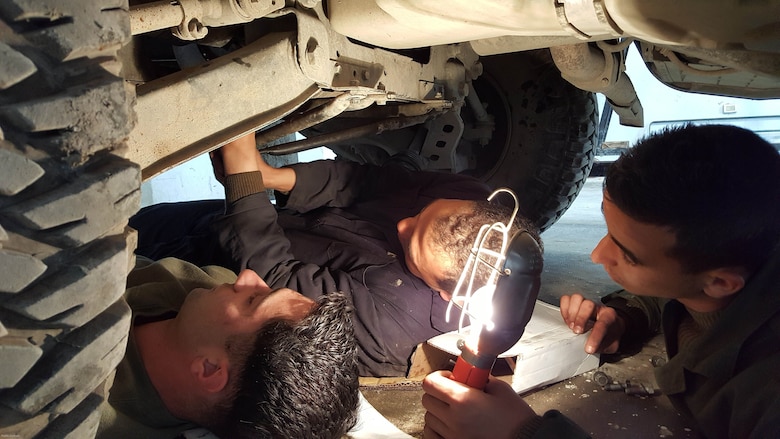 Sgt. Doug Lancie, a motor transportation mechanic, works with a Tunisian Groupement des Forces Speciales soldier during HMMWV maintenance training in Bizerte, Tunisia, Mar. 21- Apr. 8, 2016. The Marine vehicle maintenance and assistance team trained with the GFS to increase counter terrorism capabilities through motor transportation operations and maintenance training. 