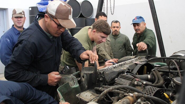 Cpl. Josh Sizelove, a motor transportation mechanic, works with Tunisian Groupement des Forces Speciales soldiers on engine parts of a HMMWV during training in Bizerte, Tunisia, Mar. 21- Apr. 8, 2016. The Marine vehicle maintenance and assistance team trained with the GFS to increase counter terrorism capabilities through motor transportation operations and maintenance training. 
