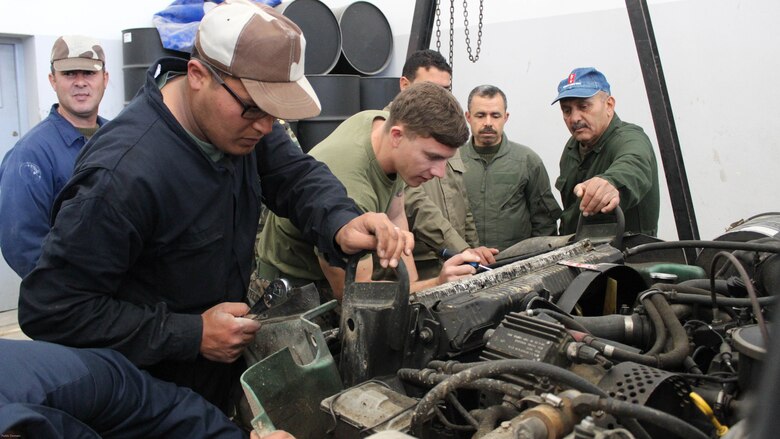 Cpl. Josh Sizelove, a motor transportation mechanic, works with Tunisian Groupement des Forces Speciales soldiers on engine parts of a HMMWV during training in Bizerte, Tunisia, Mar. 21- Apr. 8, 2016. The Marine vehicle maintenance and assistance team trained with the GFS to increase counter terrorism capabilities through motor transportation operations and maintenance training. 