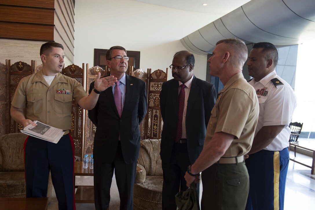 Defense Secretary Ash Carter, second from left, receives a briefing on the order of events for a repatriation ceremony in New Delhi, April 13, 2016, to mark the return of possible remains of U.S service members lost in World War II.  One set of remains, recovered by the Defense POW/MIA Accounting Agency, are possibly associated with the Jan. 25, 1944, crash of a B-24 Liberator bomber with eight crew members aboard assigned to the 308th Bomb Group, 14th Air Force. Another set, turned over to the agency, are possibly related to a C-109 Liberator Express cargo aircraft that crashed July 17, 1945, with a four-man Army Air Forces crew.