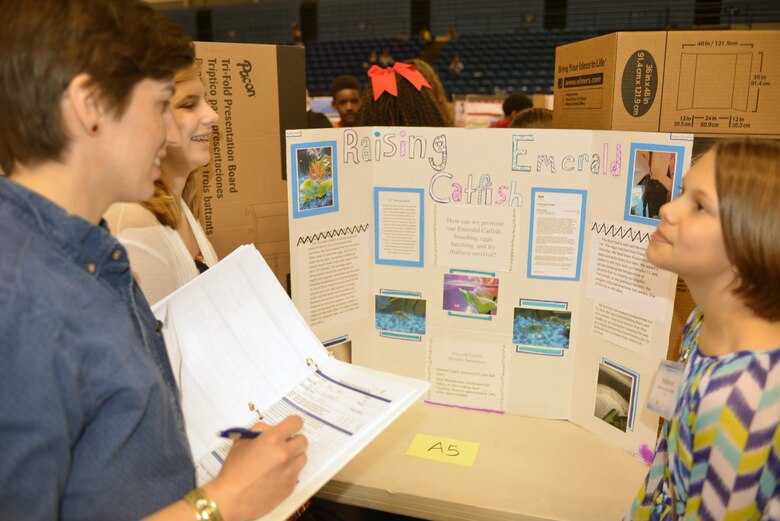 Courtney Eason, realty specialist in the Real Estate Office judges a Science, Technolgy, Engineering and Math project for students from Rucker Middle School sponsored by the Middle Tennessee STEM Innovation Hub at the Tennessee State University in 
Nashville, Tenn., on April 7, 2016.  