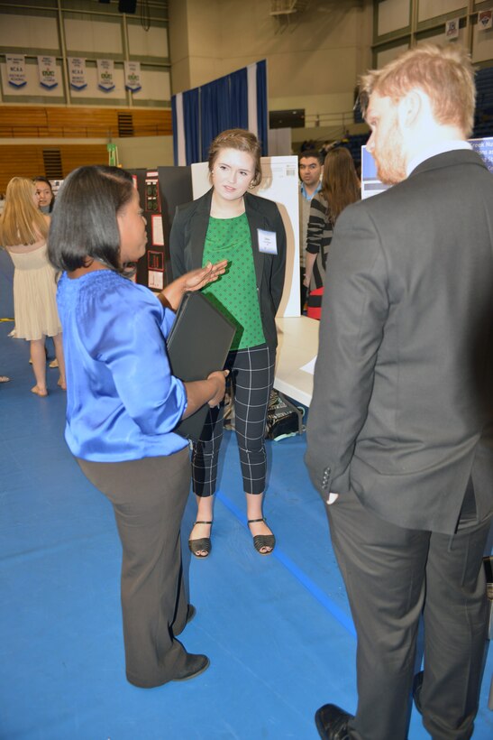 Stephanie Coleman, an Equal Employment Office specialist with the U.S. Army Corps of Engineer Nashsville District talks with Dana Stopinski and Tyler Roberts from Central Magnet High School in Murfreesboro, Tenn., a group of technical experts from the U.S. Army Corps of Engineers Nashville District attended a Science, Technology, Engineering and Mathematics Science Expo as judges and also staffed an exhibit sponsored by the Middle Tennessee STEM Innovation Hub at the Tennessee State University in Nashville, Tenn on April 7, 2016.  