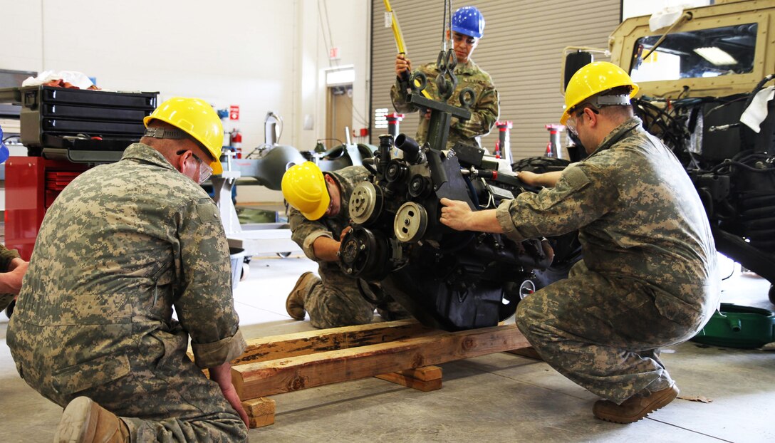 Course instructor Sgt. 1st Class Jorge Gonzalez provides guidance to students during the 80th Training Command's Wheeled Vehicle Mechanic Course at Regional Training Site-Maintenance, Ft. Devens, Mass., 30 March 2016, as they remove a Humvee’s engine. The three-week course teaches students the basics of how to perform maintenance and repairs on four-wheeled military vehicles, primarily focusing on Humvees and Mine-Resistant Ambush Protected vehicles.