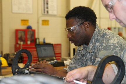 Spc. Abraham Keith, 318th Chemical Company, Birmingham, Ala. works on a Humvee during the first phase of the 80th Training Command's Wheeled Vehicle Mechanic Course at Regional Training Site-Maintenance-Fort Devens, 31 March 2016.   The three-week course teaches students the basics of how to perform maintenance and repairs on four-wheeled military vehicles, primarily focusing on Humvees and Mine-Resistant Ambush Protected vehicles.