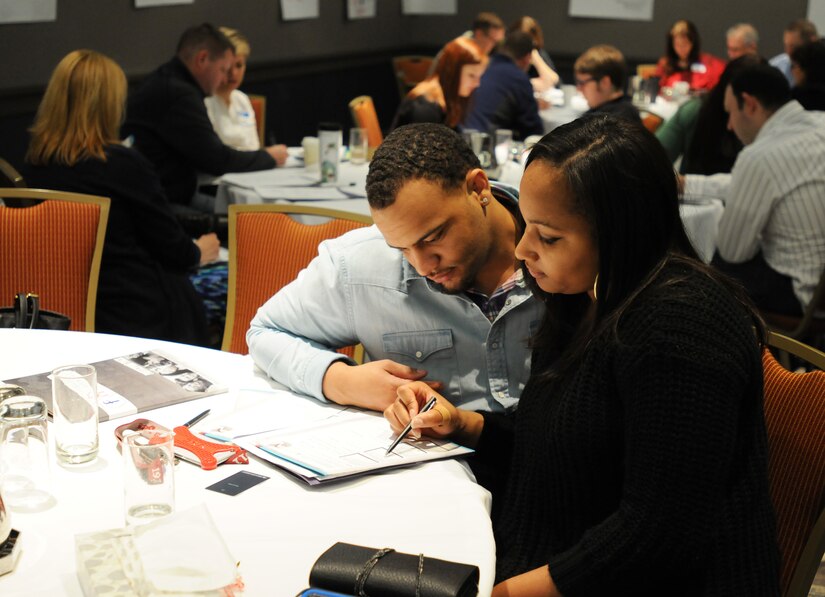 Army Reserve Soldiers Spec. Bradley and Staff Sgt. Arianna Joe, who have been married for three months, review a hand-out together during a Strong Bonds event conducted at the Hilton Oak Brook Hills Resort in Oak Brook, Ill, April 8-10.
Bradley and Arianna had also attended a Single Soldier Strong Bonds event long before getting married. Bradley said that foundation had helped him in many ways. 
“Everybody should go to a Strong Bonds event – even the singles.” said Bradley. “In the singles event I learned so much about myself – stuff I didn’t even know. Now we’re married and we’re learning about what we do rather than what I do, because it’s not about you and I anymore, it’s about we.”