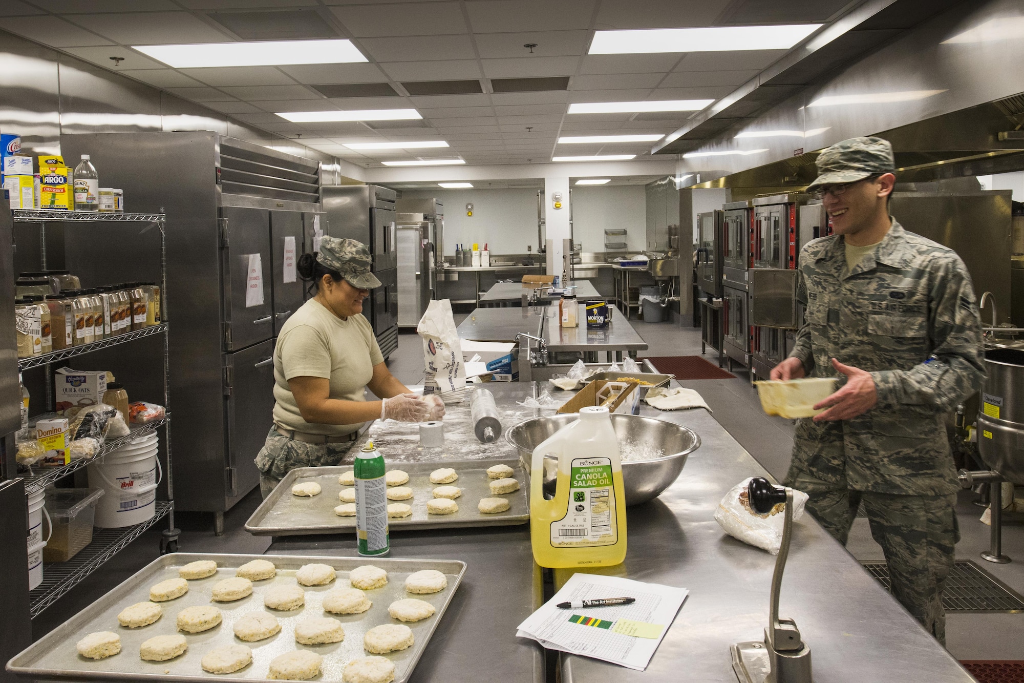 U.S. Air Force Staff Sgt. Anna Sprouse, 23d Force Support Squadron food service supervisor, and Airman 1st Class Jonathan Webb, 23d FSS food service specialist, prepare biscuits before lunch, April 7, 2016, at Moody Air Force Base, Ga. The Georgia Pines Dining Facility serves Airmen, base tours and distinguished visitors. (U.S. Air Force photo by Airman Daniel Snider/Released)