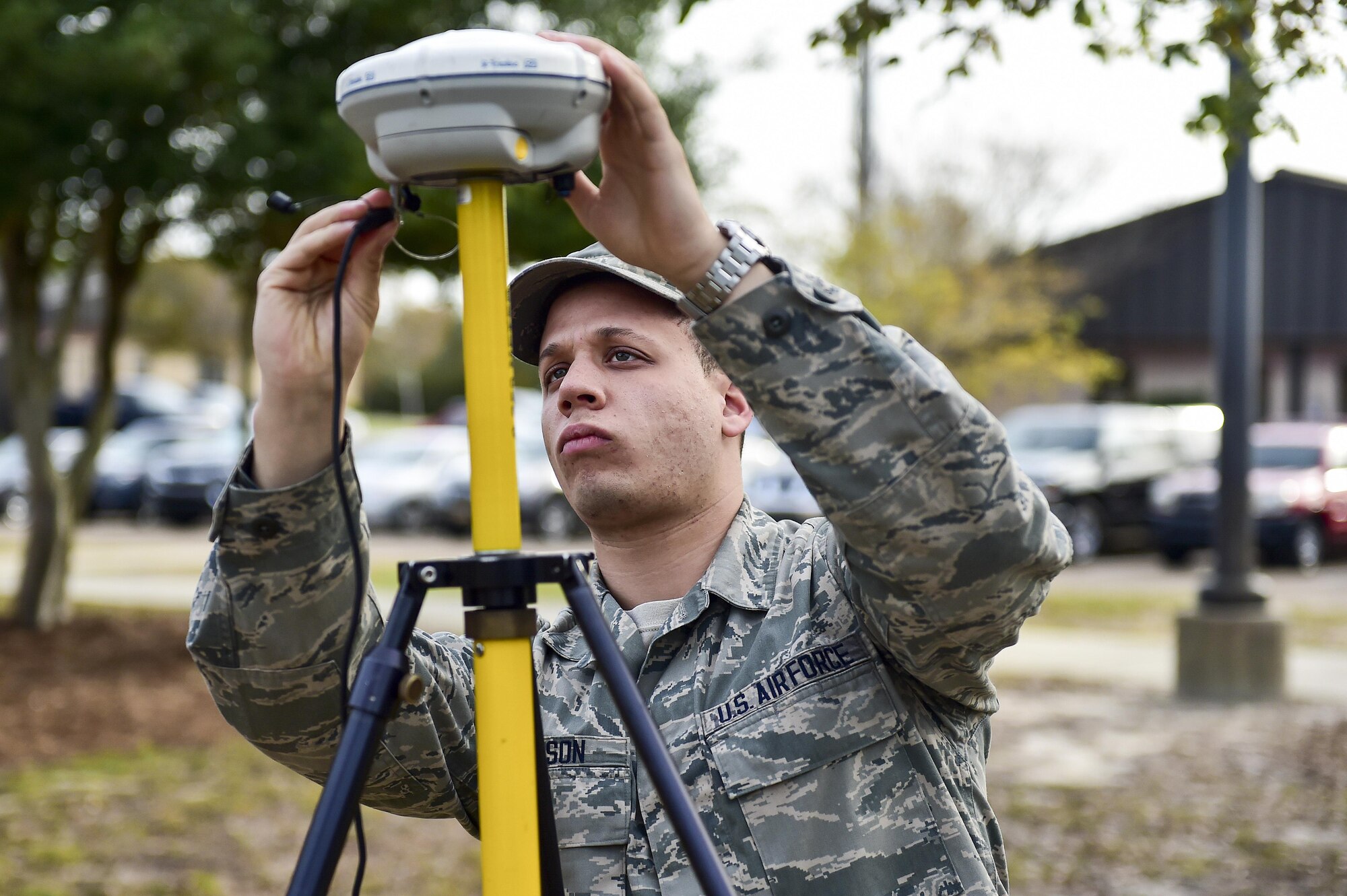 Senior Airman Adam Gleason, an engineering journeyman with the 1st Special Operations Civil Engineer Squadron, sets up an R8 receiver for a GPS rover at Hurlburt Field, Fla., March 30, 2016. The GPS rover is used to pinpoint locations on base for surveying potential construction sites or future projects. It can also be used for setting points for airfield boundaries, locations and bare base planning. (U.S. Air Force photo by Senior Airman Jeff Parkinson)