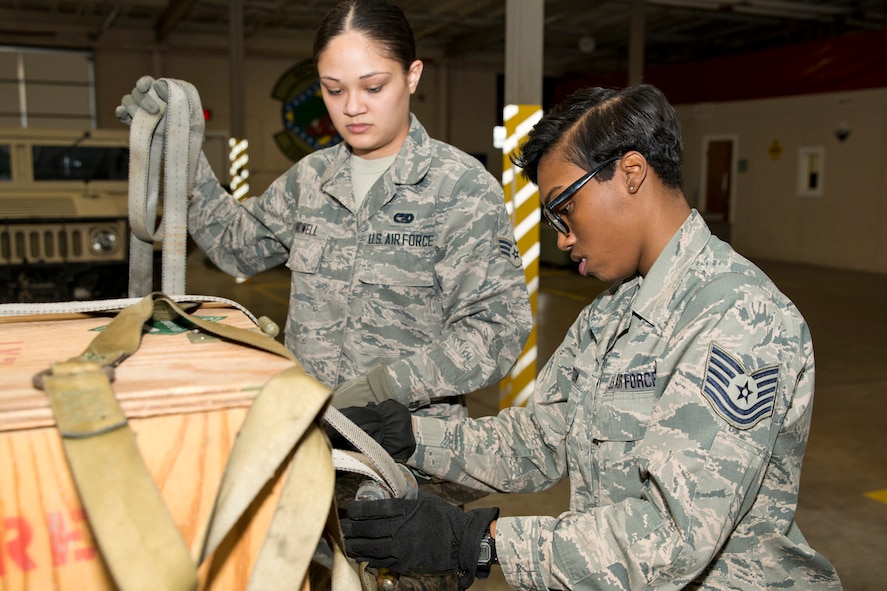 U.S. Air Force Reserve Tech. Sgt. Joi Shelton, materiel management, 913th Force Support Squadron, secures a side net to a 463L pallet under the watchful eye of course instructor, Senior Airman Melissa Bridwell, an air transportation journeyman assigned to the 96th Aerial Port Squadron, during a pallet build up course at Little Rock Air Force Base, Ark., Apr. 10, 2016. The course was offered so Airmen not assigned to air transportation units can build their own pallets of unit specific equipment for transportation. (U.S. Air Force photo by Master Sgt. Jeff Walston/released)