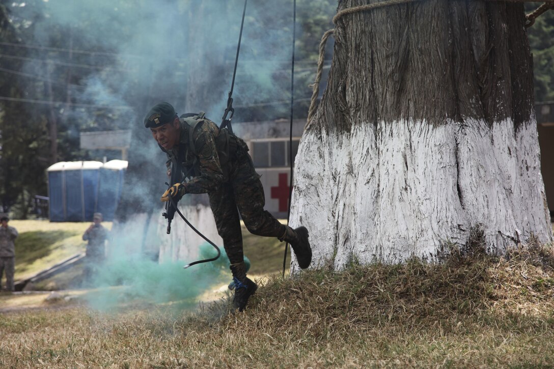 Guatemala Soldier of the Guatemalan Mountain Brigade repel down the tree at the Beyond The Horizon Opening Ceremony in San Marcos, Guatemala on April 7, 2016 as a part of Beyond The Horizon 2016 Guatemala. Task Force Red Wolf and Army South conducts Humanitarian Civil Assistance Training to include tactical level construction projects and Medical Readiness Training Exercises providing medical access and building schools in Guatemala with the Guatemalan Government and non-government agencies from 05MAR16 to 18JUN16 in order to improve the mission readiness of US Forces and to provide a lasting benefit to the people of Guatemala. (U.S. Army photo by Sgt. Ronquel Robinson/Released)