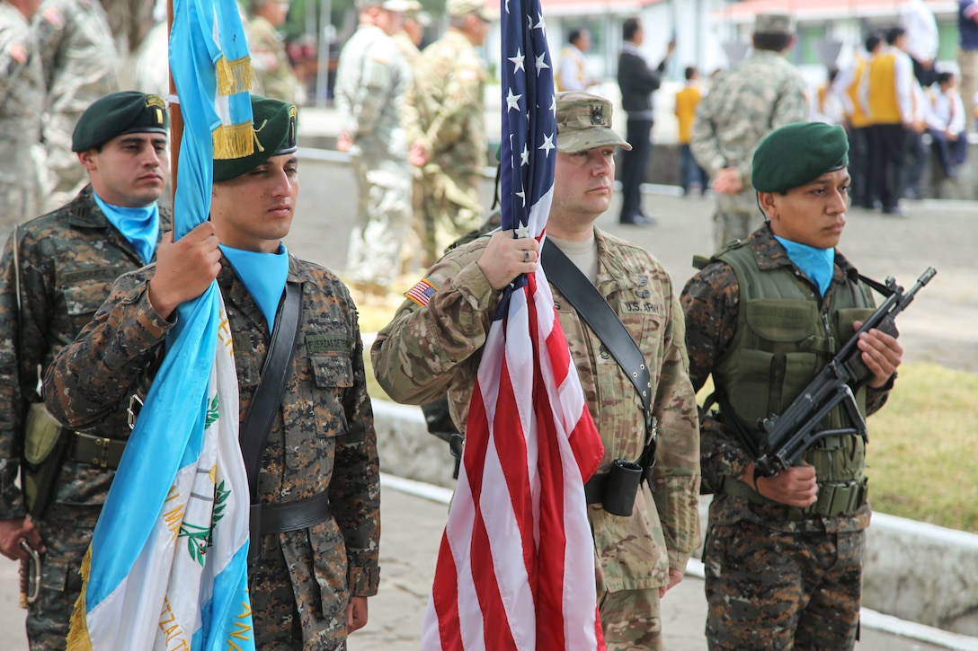 U.S. Army  Sgt. 1st Class Michael Adkins of the 130th Engineer Support Company, present the U.S. flag with members of the Guatemalan Mountain Brigade at the Beyond The Horizon Opening Ceremony in San Marcos, Guatemala on April 7, 2016 as a part of Beyond The Horizon 2016 Guatemala. Task Force Red Wolf and Army South conducts Humanitarian Civil Assistance Training to include tactical level construction projects and Medical Readiness Training Exercises providing medical access and building schools in Guatemala with the Guatemalan Government and non-government agencies from 05MAR16 to 18JUN16 in order to improve the mission readiness of US Forces and to provide a lasting benefit to the people of Guatemala. (U.S. Army photo by Sgt. Ronquel Robinson/Released)