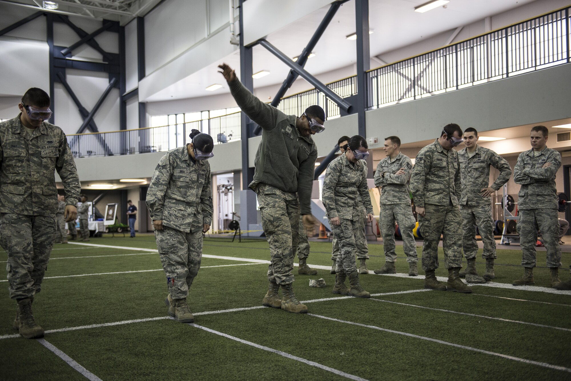 Members of the 354th Fighter Wing attempt to walk a straight line while wearing beer goggles April 8, 2016, on Eielson Air Force Base, Alaska. Eielson’s Alcohol and Drug Abuse Prevention and Treatment team offered hands-on experiences demonstrating how the body reacts while inebriated. (U.S. Air Force photo by Staff Sgt. Joshua Turner/Released)