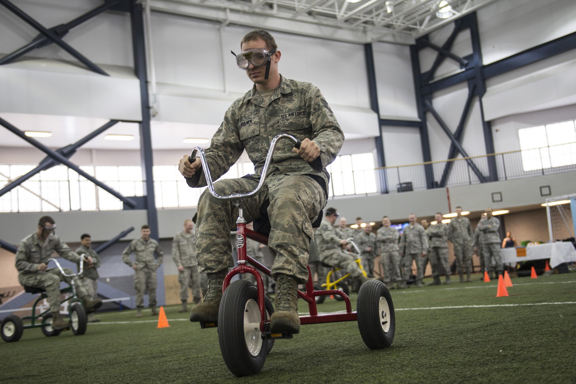 U.S. Air Force Staff Sgt. James Culver, a 354th Civil Engineer Squadron, Heating, Ventilation and Air Conditioning technician, rides a tricycle while wearing beer goggles April 8, 2016, on Eielson Air Force Base, Alaska. Eielson’s Alcohol and Drug Abuse Prevention and Treatment team offered hands-on experiences demonstrating how the body reacts while inebriated. (U.S. Air Force photo by Staff Sgt. Joshua Turner/Released)