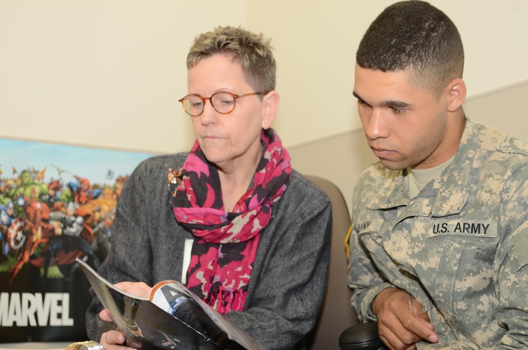 Sarah L. Hood, the Journalism Preparatory Course instructor at the Defense Information School on Fort Meade, discusses a magazine article April 8,2016, with Army Pvt. Hubert Delany, who completed J-Prep and is scheduled to graduate from the Basic Public Affairs Specialist Course at DINFOS. J-Prep is an informal 16-day class that focuses on English essentials. Although it’s not a requirement for everyone, J-Prep is designed to build confidence and improve students’ chances for success in BPASC. 