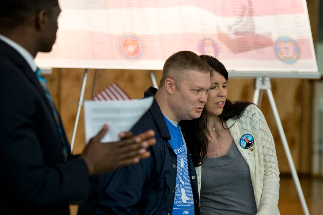 Mrs. Jennifer Legate is comforted by her brother after her inspirational speech at the 11th Annual Tribute to Fallen Heroes Ceremony in Sherwood, Ark., Apr. 9, 2016. Legate spoke about her father, Army National Guard Chief Warrant Officer 4, Patrick W. Kordsmeier, who died Apr. 24, 2004, in Taji, Iraq, when mortar rounds hit his camp. (U.S. Air Force photo by Master Sgt. Jeff Walston/released)