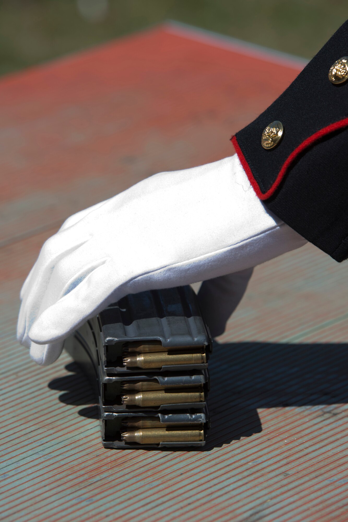 A Marine straightens magazines for use in the 3-volley salute during the 11th Annual Tribute to Fallen Heroes Ceremony in Sherwood, Ark., Apr. 9, 2016.  The Marines, assigned to India Company, 3rd Battalion, 23rd Marines, 4th Marine Division United States Marine Corp, Camp Pike, North Little Rock, Ark., fired the salute to close out the annual ceremony. (U.S. Air Force photo by Master Sgt. Jeff Walston/released) 