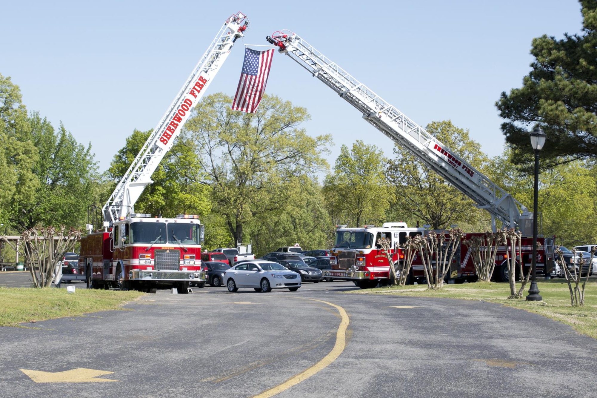 Sherwood Fire Department ladder trucks form a ladder arch for the 11th Annual Tribute to Fallen Heroes Ceremony at Sherwood Forrest in Sherwood, Ark., Apr. 9, 2016. The annual ceremony honors the memory of all Arkansans whom have made the ultimate sacrifice as a result of the war against terrorism.  (U.S. Air Force photo by Master Sgt. Jeff Walston/released) 