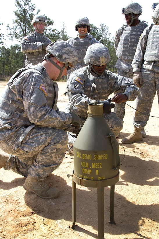 Army Spc. Mark Sawyer, left, and Sgt. Robert Brown, prepare a shape charge that will be used to blast a six-foot hole into wet, compacted soil at McCrady Training Center, in Eastover, S.C. April 10, 2016. Sawyer is assigned to the Florida National Guard’s 868th Engineer Company and Brown is assigned to the Florida National Guard’s 869th Engineer Company. Air National Guard photo by Sgt. Brad Mincey