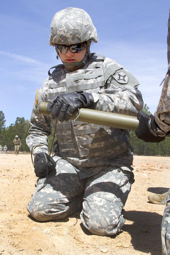 Army Pvt. 1st Class Candice Davis wraps detonation cord around a bangalore torpedo that combat engineers use to clear routes of minefields and concertina wire during training at McCrady Training Center, in Eastover, S.C. April 10, 2016. Davis is assigned to the Florida National Guard’s 868th Engineer Company. Air National Guard photo by Sgt. Brad Mincey