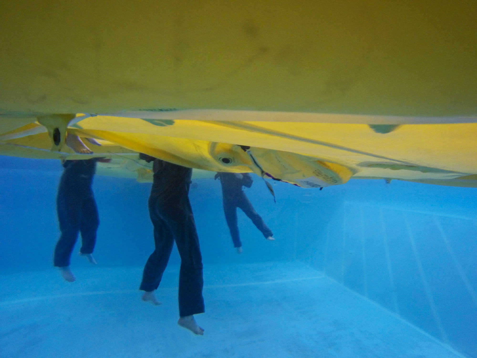 An underwater photo o 709th Airlift Squadron members treading water during their water survival portion of their recurring training, April 1, 2016, at Naval Air Station Pensacola, Fla. Reservists from Dover Air Force Base, Del., in the 512th Airlift Wing, conducted an off-station training exercise March 29 to April 3 to ensure they are current in all their deployment requirements. (U.S. Air Force photo/Capt. Bernie Kale)