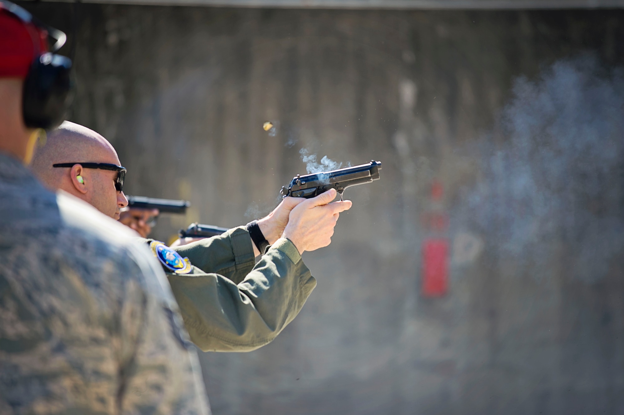 Master Sgt. Tim Morgan, a loadmaster with the 709th Airlift Squadron, fires his 9mm pistol down the firing range, April 1, 2016, at Naval Air Station Pensacola, Fla., as part of his weapons qualification training. Combat Arms reservists from the 512th Security Forces Squadron, from Dover Air Force Base, Del., trained the aircrews at the off-station event, March 29 to April 3, to ensure the safety a security of the reservists in future deployments. (U.S. Air Force Photo/Capt. Bernie Kale)