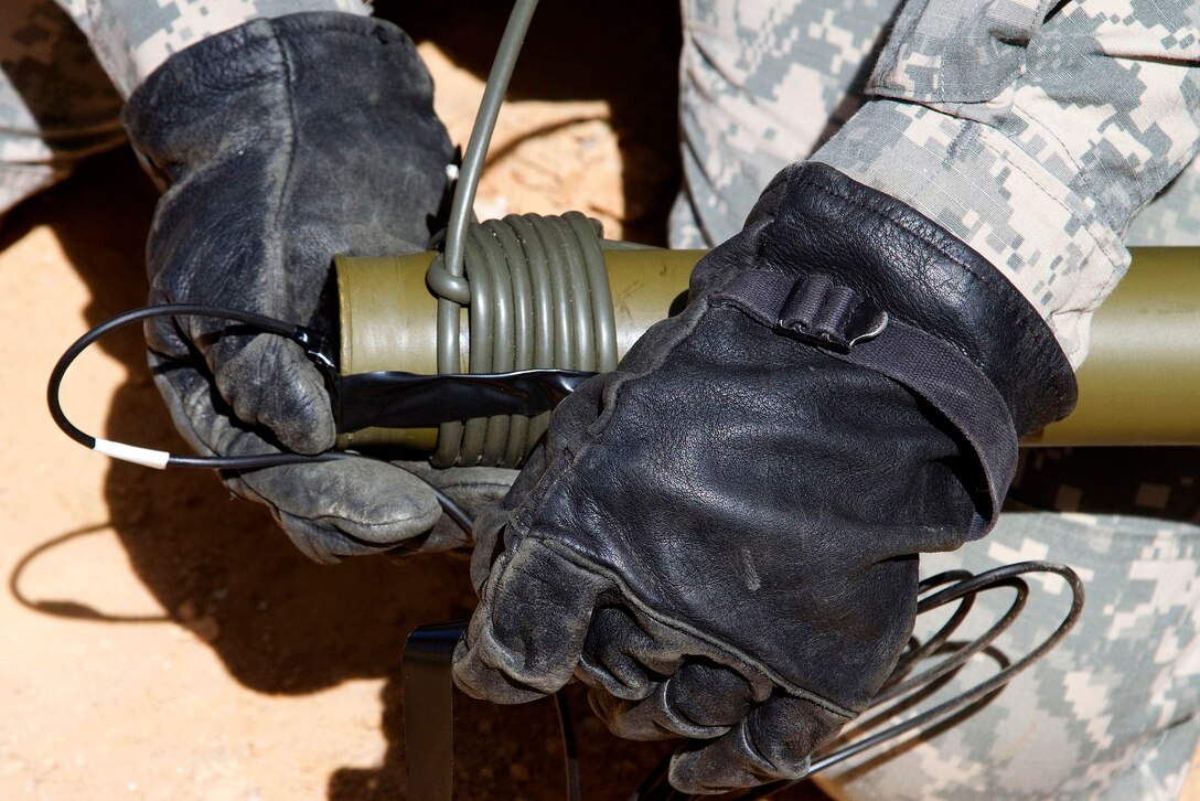 Army Pvt. 1st Class Candice Davis finishes wrapping detonation cord around a bangalore torpedo that combat engineers use to clear routes of minefields and concertina wire during training at McCrady Training Center, in Eastover, S.C. April 10, 2016. Davis is assigned to the Florida National Guard’s 868th Engineer Company. Air National Guard photo by Sgt. Brad Mincey