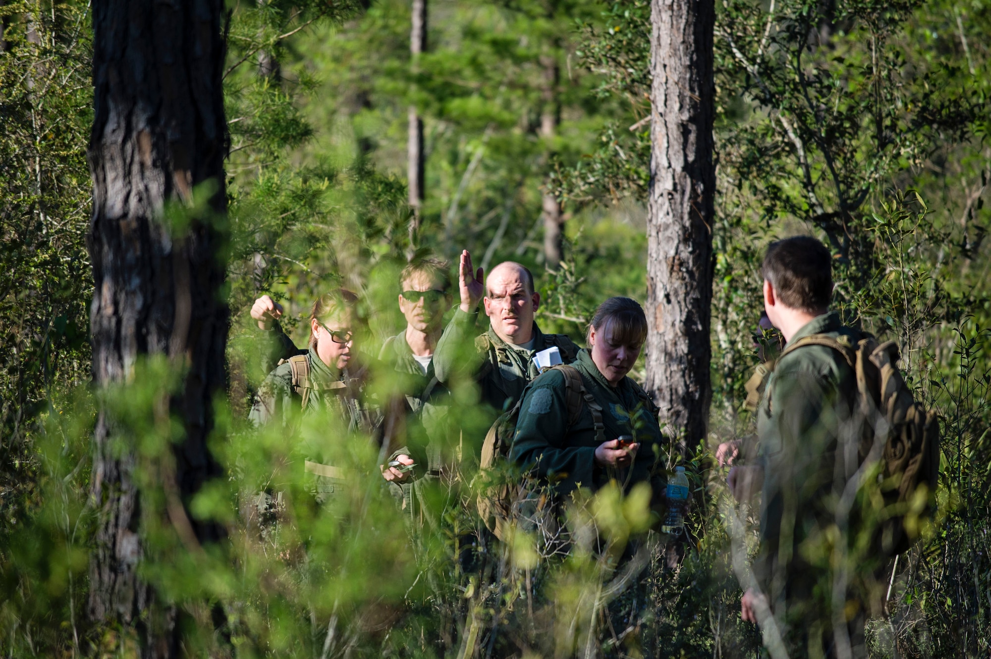 Reservists from Dover Air Force Base, Del., in the 709th Airlift Squadron, navigate their way through the swamps of Naval Air Station Pensacola, Fla., April 2, 2016, during their evasion portion of the combat training. The aircrews conducted an off-station training exercise, March 29 to April 3, to ensure they are current in all their deployment requirements. (U.S. Air Force photo/Capt. Bernie Kale) 