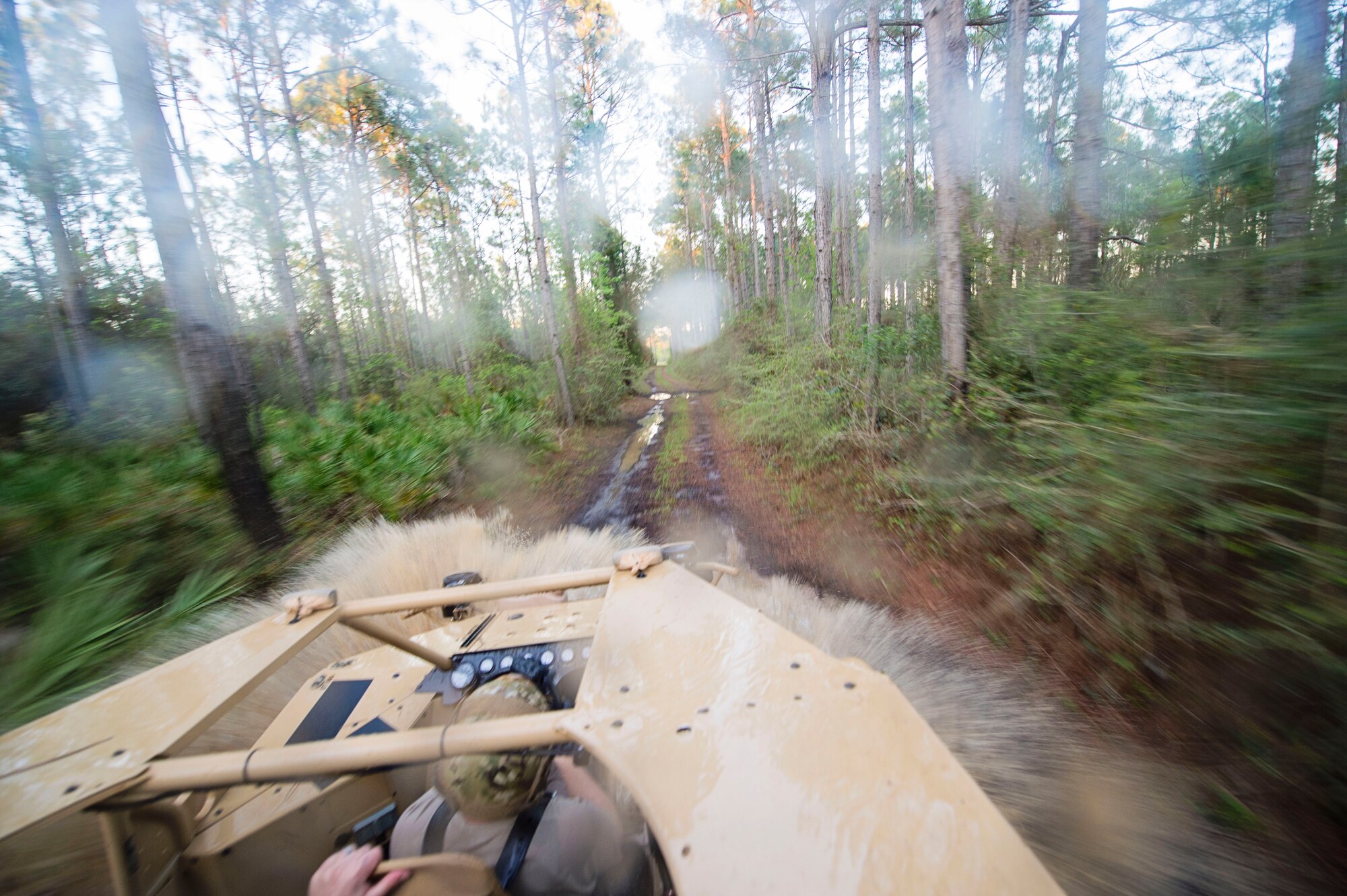 The driver of a Guardian Angel Air Deployable Rescue Vehicle drives through water on the off-road trail while rescuing simulated escaped prisoners of war in the swamp at Naval Air Station Pensacola, Fla., April 2, 2016. Reservists from Dover Air Force Base, Del., in the 512th Airlift Wing's 709th Airlift Squadron, conducted an off-station training exercise, March 29 to April 3, to ensure they are current in all their deployment requirements. (U.S. Air Force photo/Capt. Bernie Kale)