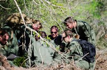 Reservists from Dover Air Force Base, Del., in the 709th Airlift Squadron, navigate their way through the swamps of Naval Air Station Pensacola, Fla., April 2, 2016, during their evasion portion of the combat training. The aircrews conducted an off-station training exercise, March 29 to April 3, to ensure they are current in all their deployment requirements. (U.S. Air Force photo/Capt. Bernie Kale) 