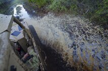The driver of a Guardian Angel Air Deployable Rescue Vehicle drives through water on the off-road trail while rescuing simulated escaped prisoners of war in the swamps at Naval Air Station Pensacola, Fla., April 2, 2016. Reservists from Dover Air Force Base, Del., in the 512th Airlift Wing's 709th Airlift Squadron, conducted an off-station training exercise, March 29 through April 3, to ensure they are current in all their deployment requirements. (U.S. Air Force photo/Capt. Bernie Kale)