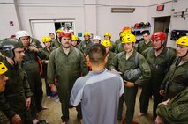 A Survival, Evasion, Resistance and Escape instructor (center) educates Reservists from Dover Air Force Base, Del., in the 512th Airlift Wing, on the process of the water survival training scenario, April 1, 2016, at Naval Air Station Pensacola, Fla. The squadron conducted an off-station training exercise March 29 through April 3 to ensure they are current in all their deployment requirements. (U.S. Air Force photo/Capt. Bernie Kale)