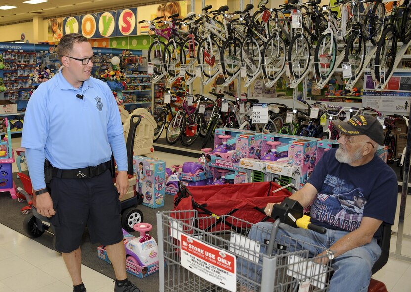 U.S. Air Force Staff Sgt. Johnny Nunnes, 355th Security Forces Squadron base defense operations center controller, speaks with Tom Perrow, World War II veteran, about the bicycle patrol fleet at Davis-Monthan Air Force Base, Ariz., April 8, 2016. The fleet is a section within the 355th SFS that allows the “defenders” not only more access to the base but more interaction with the D-M AFB community. (U.S. Air Force photo by Airman 1st Class Mya M. Crosby/Released)