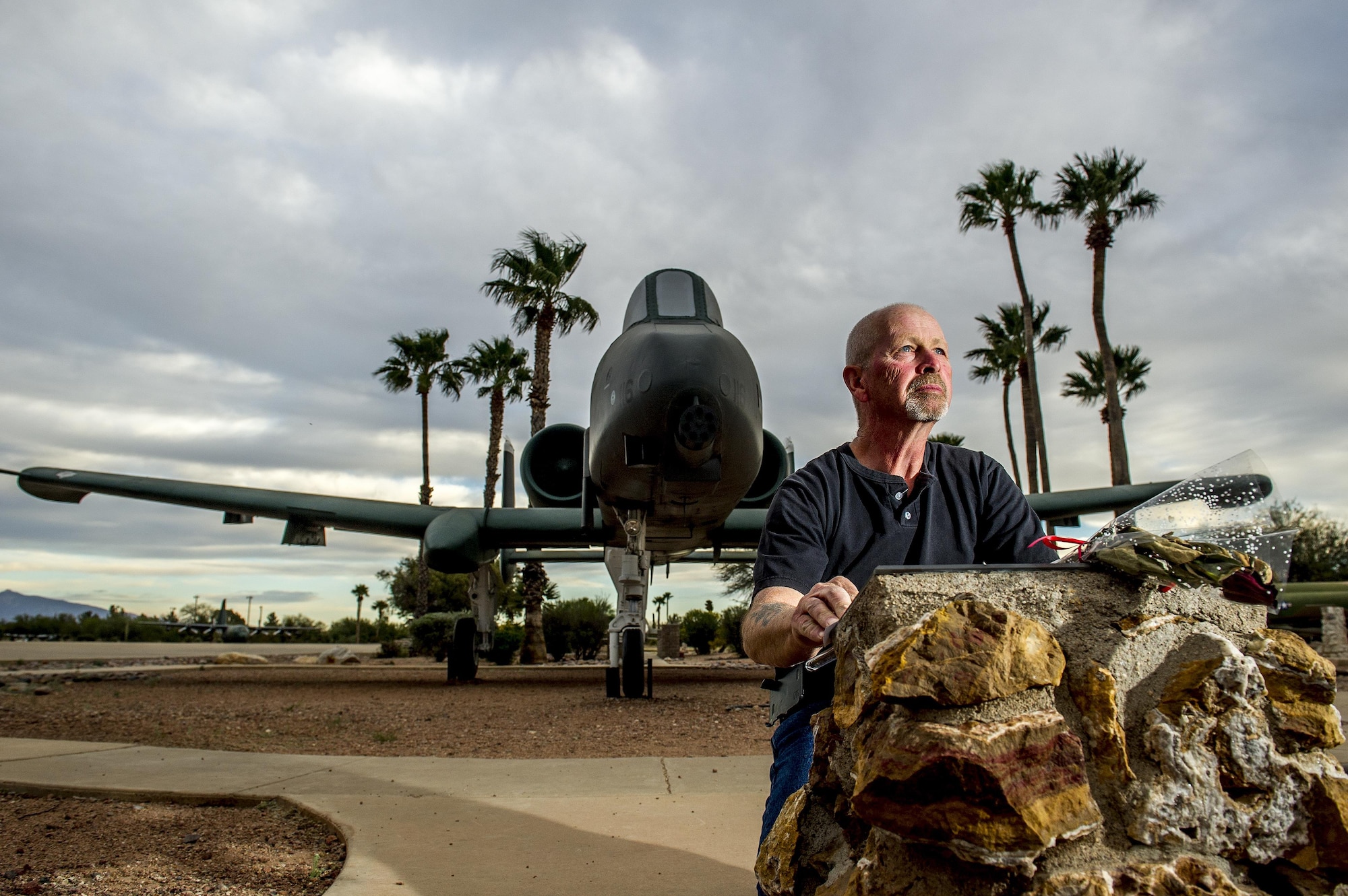 Richard Brunt, 59, touches a memorial plaque, located in Heritage Park at Davis-Monthan Air Force Base, Ariz., March 5, 2016, which honors Captain Patrick B. Olson, who died on Feb. 27,1991, while trying to land a heavily damaged OA-10 during Operation Desert Storm. Brunt, who was Olson's crew chief, now works as a technician at the 309th Aerospace Maintenance and Regeneration Group, or the "Boneyard" at D-M AFB, removing parts from decommissioned OA-10s to build inventories used by active A-10 Thunderbolt squadrons for maintaining their aircraft. (U.S. Air Force photo by J.M. Eddins Jr.)