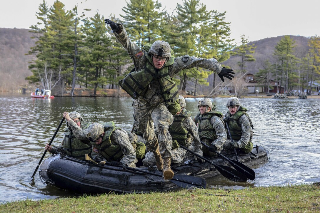 An Army cadet jumps off the front of an inflatable boat during the 2016 Sandhurst Competition at West Point, N.Y., April 9, 2016. The competition tests a team’s ability to perform specified tasks that are both mentally and physically challenging. Army photo by Sgt. 1st Class Brian Hamilton