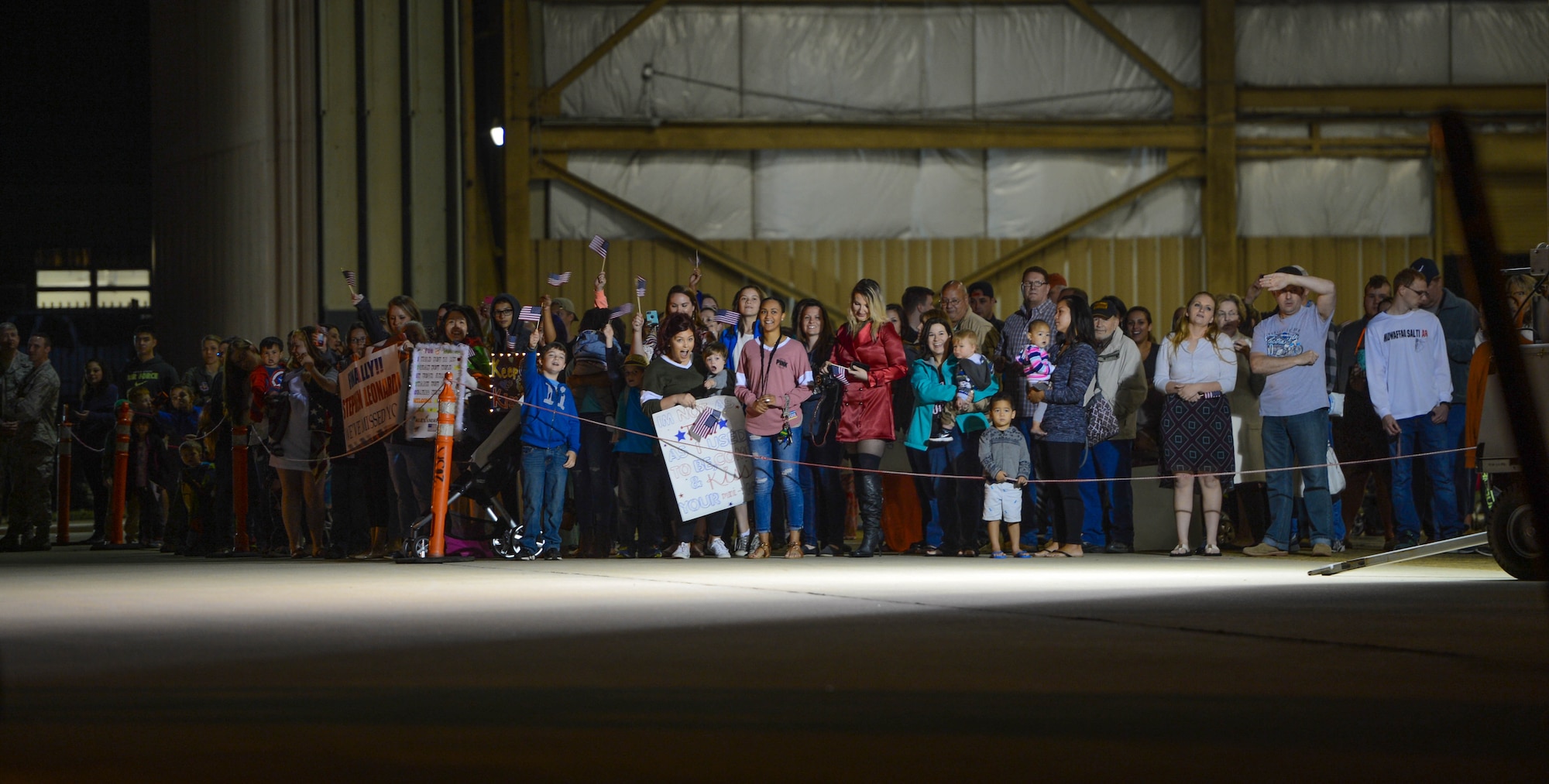 Team Shaw family members await the return of deployed 20th Fighter Wing Airmen at Shaw Air Force Base, S.C., April 13, 2016. Approximately 300 Airmen deployed for six months to the United States Central Command Area of Responsibility. (U.S. Air Force photo by Senior Airman Jensen Stidham)
