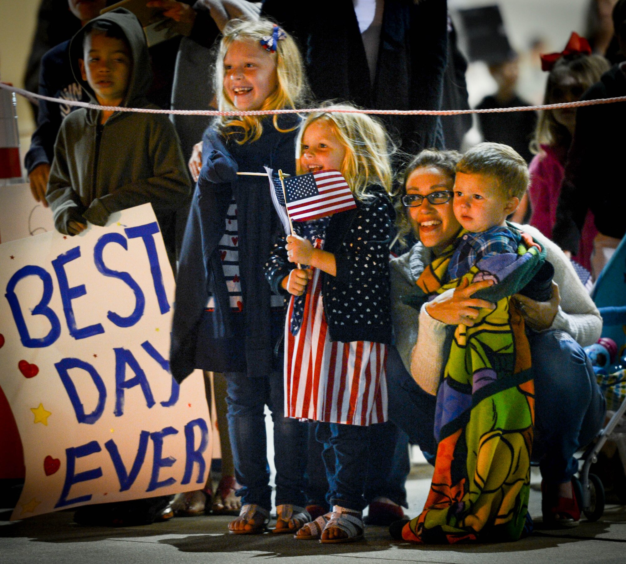 Team Shaw family members await the return of deployed 20th Fighter Wing Airmen at Shaw Air Force Base, S.C., April 13, 2016. Approximately 300 Airmen deployed for six months to the United States Central Command Area of Responsibility. (U.S. Air Force photo by Senior Airman Jensen Stidham)
