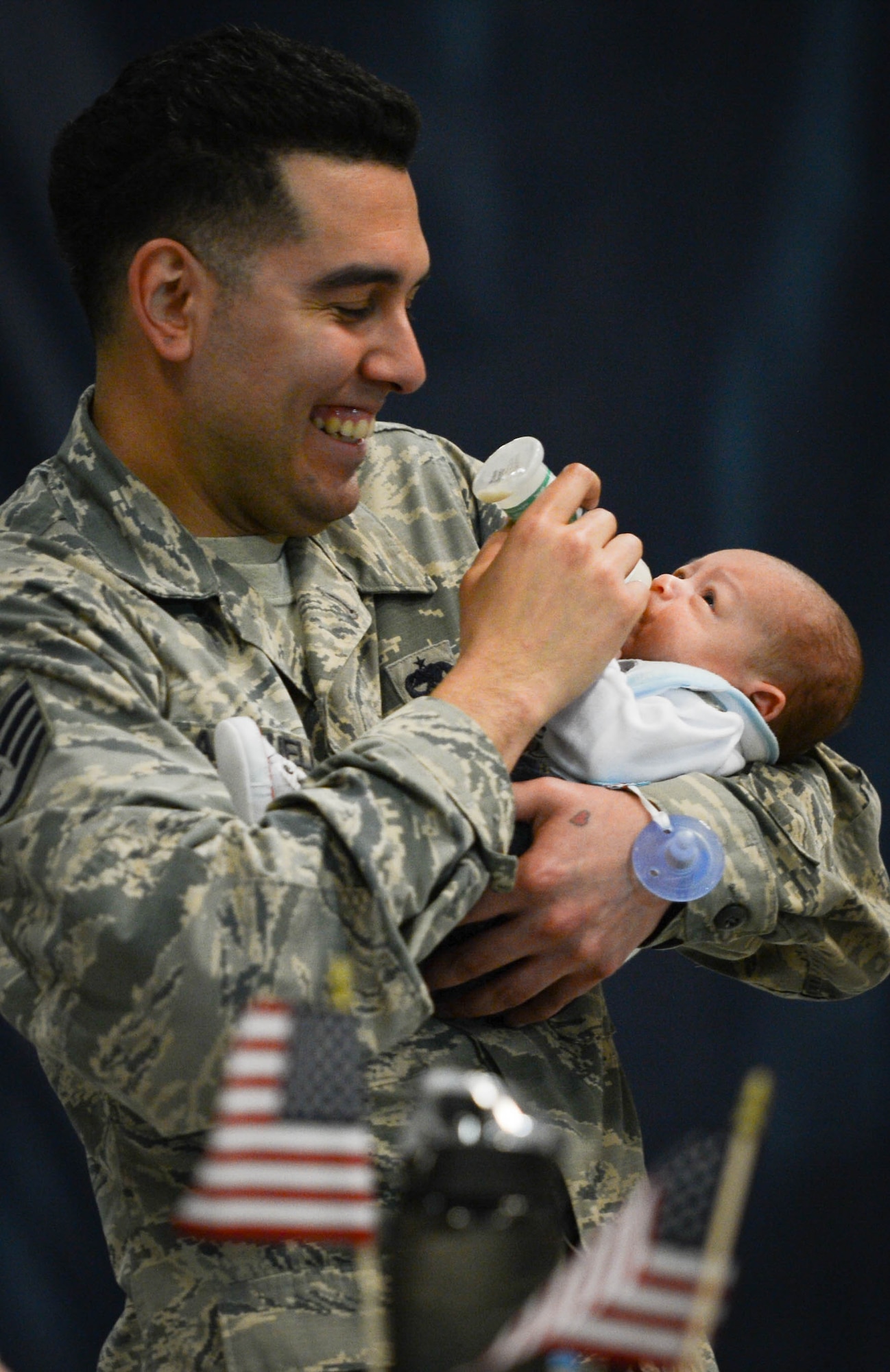 A U.S. Airman assigned to the 20th Fighter Wing holds his child for the first time after returning from a deployment to Shaw Air Force Base, S.C., April 13, 2016. Approximately 300 Airmen deployed for six months to the United States Central Command Area of Responsibility. (U.S. Air Force photo by Senior Airman Jensen Stidham)