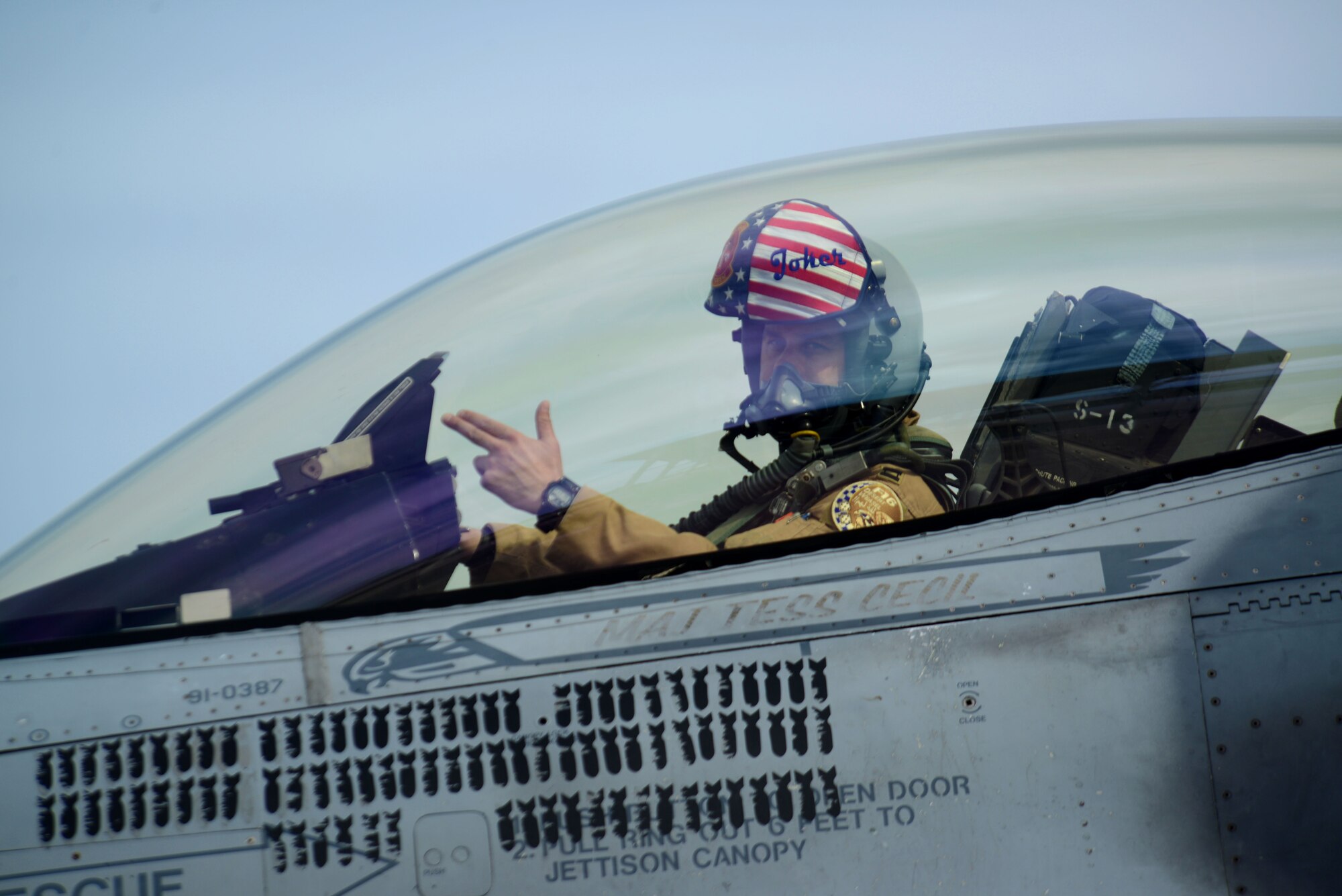 A U.S. Airman assigned to the 20th Fighter Wing gives his squadron’s hand sign as he returns to Shaw Air Force Base, S.C., April 10, 2016. Approximately 300 Airmen deployed to the United States Central Command Area of Responsibility for six months. (U.S. Air Force photo by Airman 1st Class Kelsey Tucker)