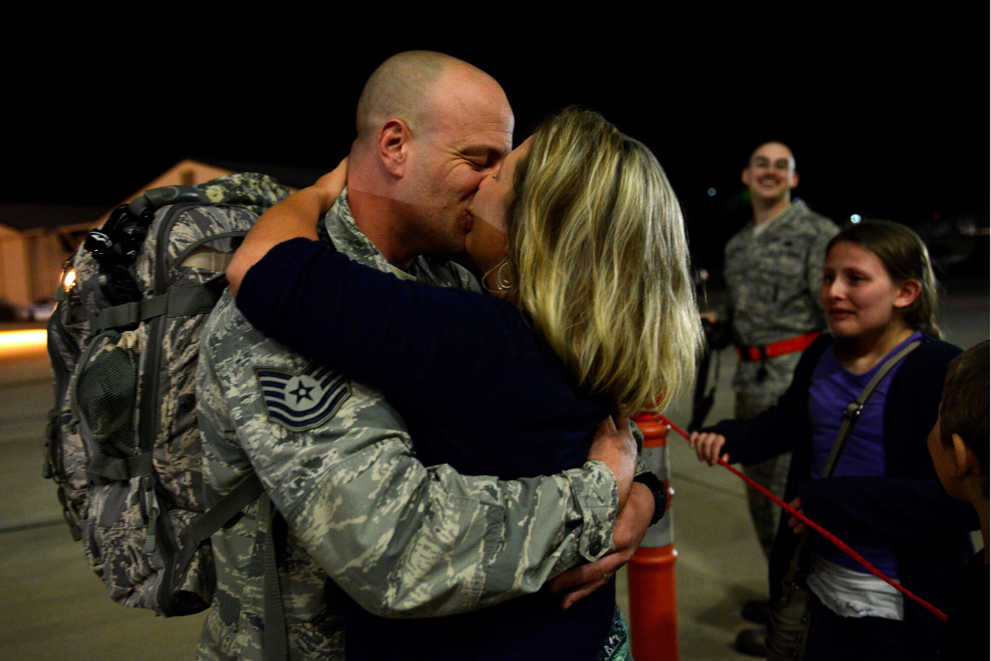 A U.S. Air Force Airman assigned to the 20th Fighter Wing kisses his significant other after returning to Shaw Air Force Base, S.C., April 13, 2016. Approximately 300 Airmen returned from a six-month deployment to the United States Central Command Area of Responsibility. (U.S. Air Force photo by Airman 1st Class Destinee Dougherty)