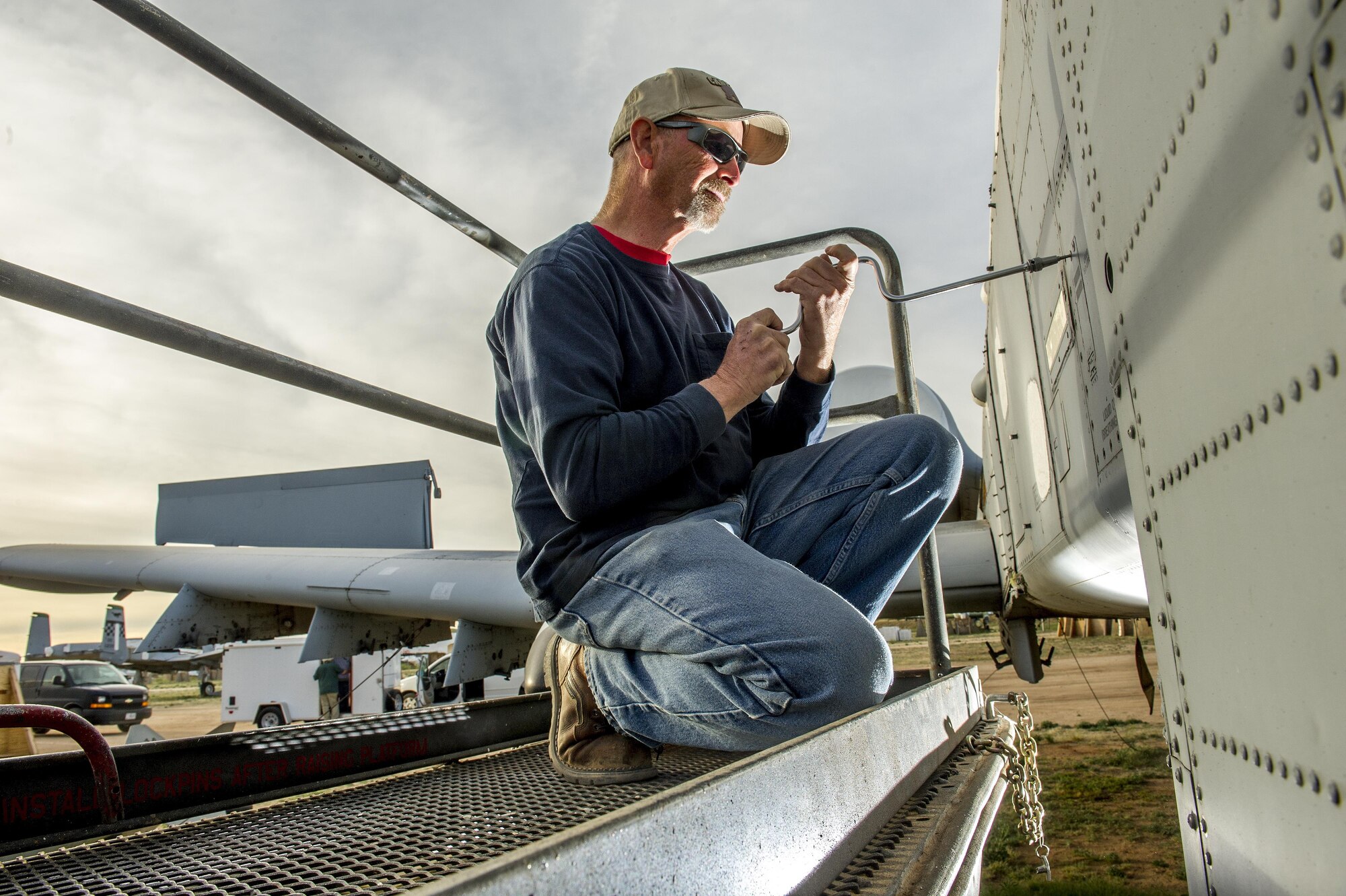 Richard Brunt, 59, removes a panel on an OA-10 at the 309th Aerospace Maintenance and Regeneration Group, or the "Boneyard" at Davis-Monthan Air Force Base, Ariz., March 4, 2016. After many years as an OA-10 crew chief, Brunt is now removing parts from decommissioned OA-10s to build inventories used by active A-10 Thunderbolt squadrons for maintaining their aircraft. (U.S. Air Force photo by J.M. Eddins Jr.)
