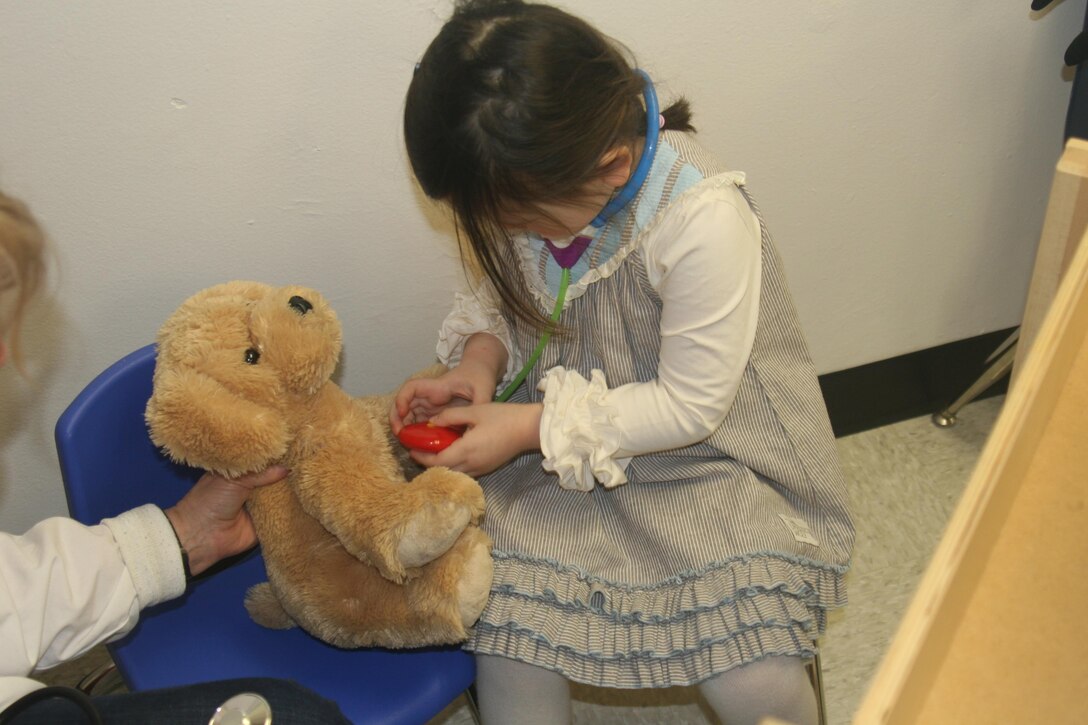 Scarlett, 3, checks her puppy Rocky’s blood pressure at the Teddy Bear Clinic, held Apr. 8 in the New Parent Support Program offices aboard Marine Corps Base Quantico. The event, which showcased different resources available on base for parents and young children, was held in honor of Child Abuse Prevention Month.