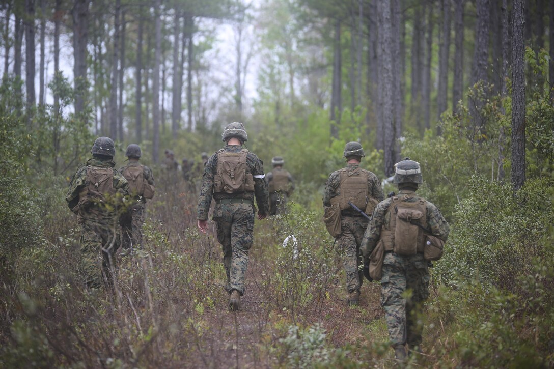Marines with 2nd Battalion, 8th Marine Regiment patrol through the woods during a platoon attack training event at Camp Lejeune, N.C., April 12, 2016. The Marines were tasked to determine the best routes that allowed them to conceal their position and achieve fire superiority.
