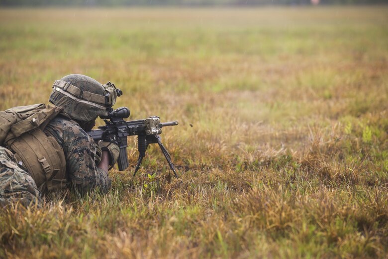 Lance Cpl. Tevin Brown, an automatic rifleman with 2nd Battalion, 8th Marine Regiment, engages simulated enemy targets during a platoon attack training event at Camp Lejeune, N.C., April 12, 2016.  The training focused on guaranteeing the Marines are confident in employing their combat skills in future foreign hostile environments.