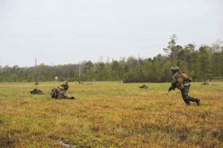 Sgt. Eric Aldridge, squad leader for 2nd Battalion, 8th Marine Regiment, runs to get into a prone position during a platoon attack training event at Camp Lejeune, N.C., April 12, 2016. The training allowed leaders to identify areas within the unit that required additional practice to improve their combat effectiveness.