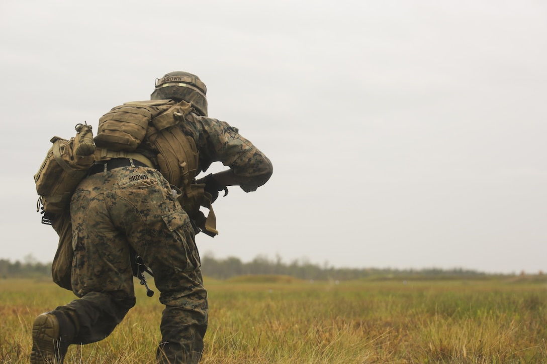 Lance Cpl. Tevin Brown, an automatic rifleman with 2nd Battalion, 8th Marine Regiment, charges toward an objective during a platoon attack training event at Camp Lejeune, N.C., April 12, 2016. The training event afforded the Marines an opportunity to develop and improve their strategies under stressful combat situations.
