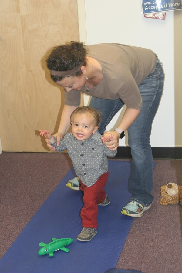 Lofton, 17 months, does yoga with the help of his mother at the Teddy Bear Clinic and New Parent Support Program Open House aboard Marine Corps Base Quantico.
