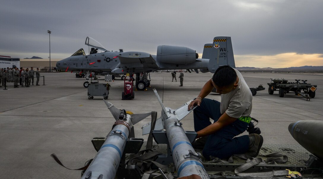 Senior Airman Fong Thao, 57th Aircraft Maintenance Squadron Raptor AMU weapons load crew member, unhooks munitions  during the 57th Wing Load Crew of the Quarter Competition at Nellis Air Force Base, Nev., April 8, 2016. In addition to recognizing superior performers, load crew competitions also help keep weapons loaders’ skills sharp and ready for real world situations.