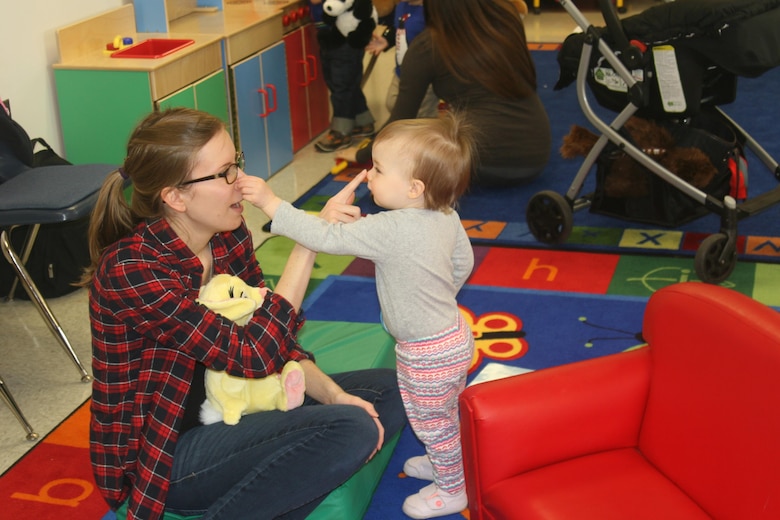 Lisa Griffith and daughter Jordan, 19 months, find each other’s noses at the songs and stories station, which was part of a Teddy Bear Clinic and Open House held Apr. 8 in the New Parent Support Program offices aboard Marine Corps Base Quantico in honor of Child Abuse Prevention Month.