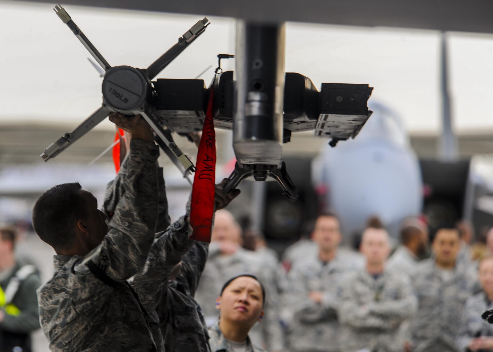 The load crew from Strike AMU loads an armament during the 57th Wings Load Crew of the Quarter Competition at Nellis Air Force Base, Nev., April 8, 2016. Strike AMU is responsible for the aircraft maintenance of the F-15 Strike Eagle at Nellis AFB. (U.S. Air Force photo by Airman 1st Class Kevin Tanenbaum)