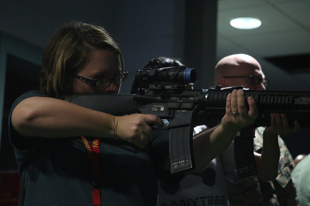 Stacy Sanders, band director from Newton County High School, prepares to practice using an M16 at the Indoor Simulated Marksmanship Training facility aboard Marine Corps Recruit Depot Parris Island, S.C., April 13, 2016. The teachers, coaches, and principals of Recruiting Stations Jacksonville and Montgomery participate in a three-day workshop designed to inform educators about military service and life in the Marine Corps. (Official Marine Corps photo Cpl. John-Paul Imbody)