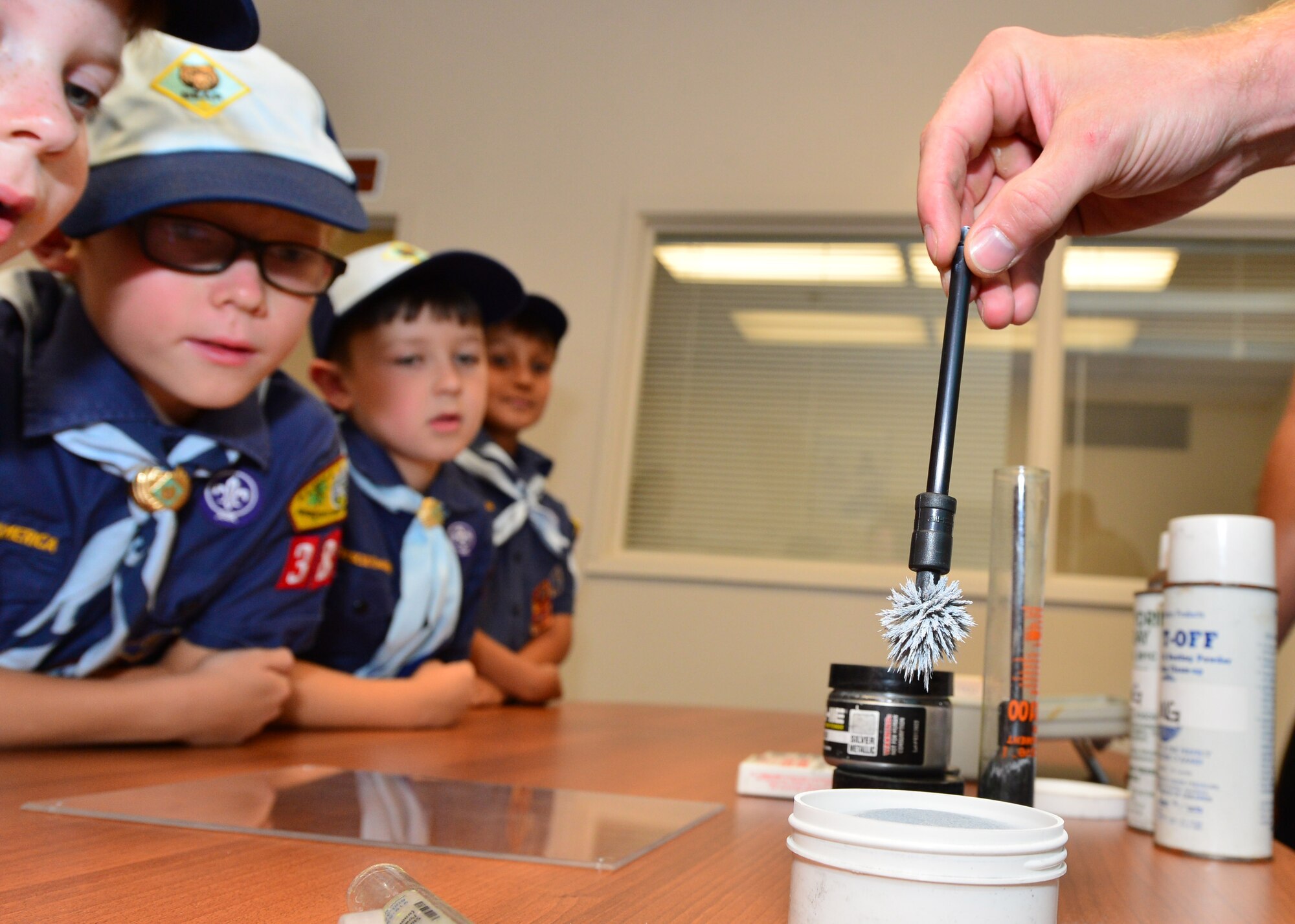 Cub Scouts from Pack 388 learn different methods used to lift finger prints during a tour of the 647th SFS on Joint Base Pearl Harbor-Hickam, April 5, 2016. During the tour, members of the 647th SFS provided weapon, fingerprint and vehicle demonstration to the Cub Scouts in Den Five of Pack 388. (U.S. Air Force photo by Tech. Sgt. Aaron Oelrich/Released)